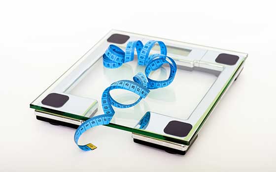 A measuring tape and a square weighing scale