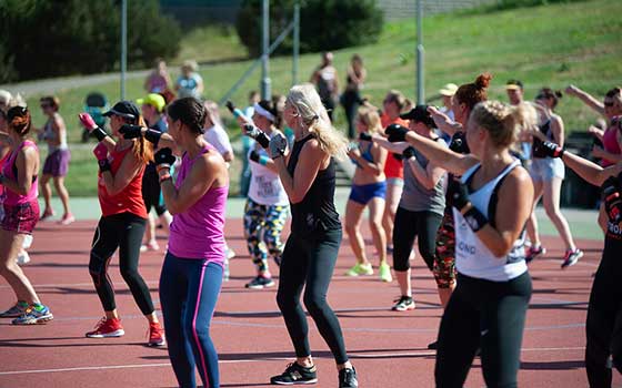 Women doing group training outside