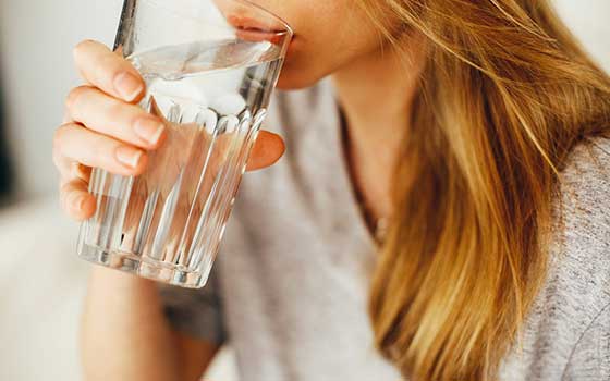 : A woman having a glass of water